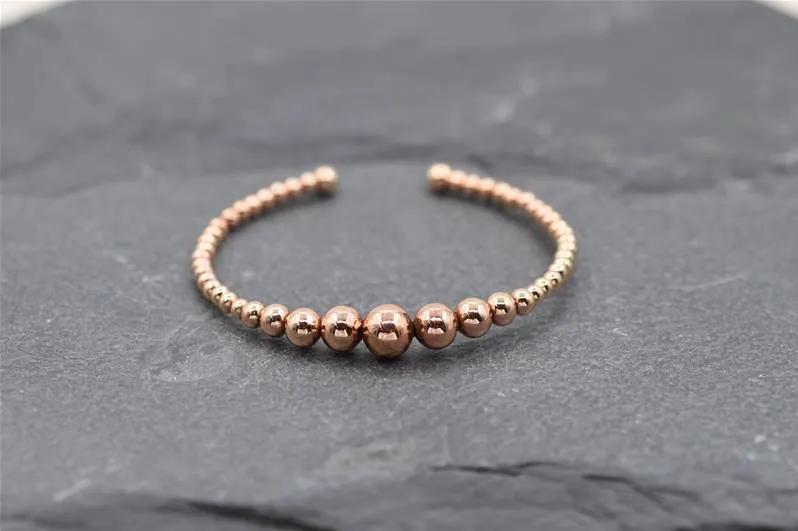 Graduated open delicate ball bangle